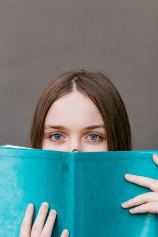 girl looking over a book