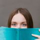 girl looking over a book